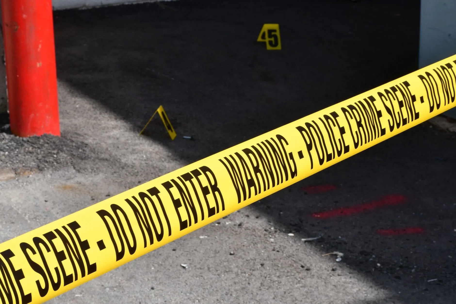 Yellow police tape on concrete